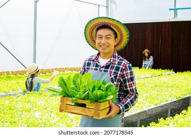 Asian Family Smile And Happiness With Their Farming Business.Greenhouse Bio Farming.Agriculture Vegetable People.Small Business Farmer.Happy Thai Group Success Modern Smart Farm.