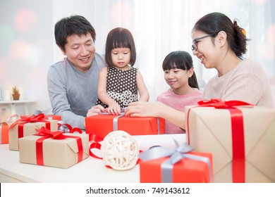 Asian Family In Sofa Giving Presents For Christmas, Asian Family Celebrate Christmas Boxing Day Open The Gift