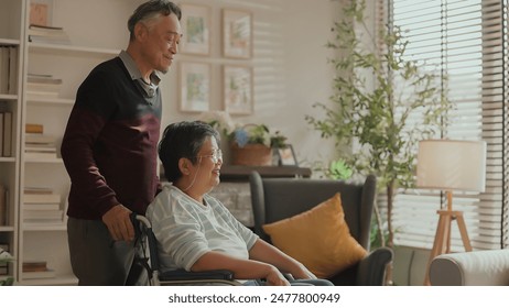 asian family spend time together encourage takecare.Husband embrace his wife in wheelchair with love asian retired couple taking and support his disable wife Vibrant senior couple embrace laugh  - Powered by Shutterstock