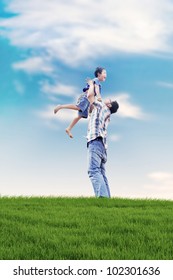 Asian Family Spending A Fun Summer Day In Meadow