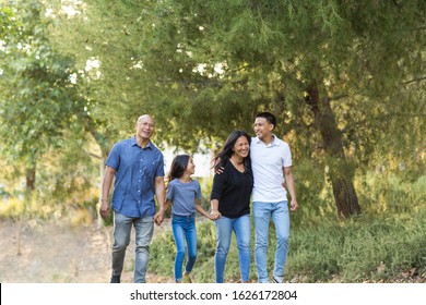 Asian family taking a walk outside and talking.