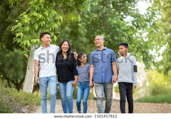 Asian family\
taking a walk outside and\
talking.