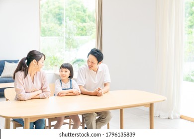 Asian Family Talking In Modern Interior.