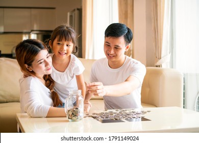 Asian Family Teach Asian Cute Girl Saving Money Putting Coins Into Piggy Glass Bank, Vintage Tone. Education, Save Money, Asian Family, Investment, Future Investment Or Family Relationship Concept