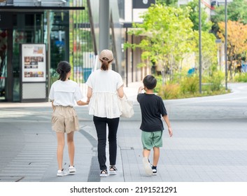 Asian Family Of Three Who Are Shopping