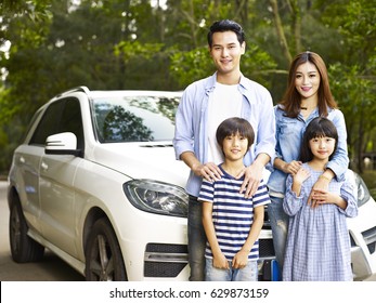 Asian Family With Two Children Taking A Photo During Travel By Car.