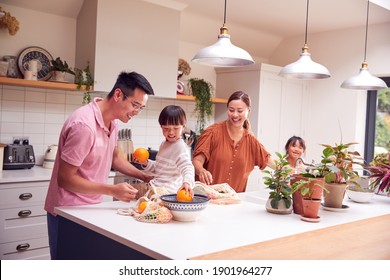 Asian Family Unpacking Local Food In Zero Waste Packaging From Bag In Kitchen At Home - Powered by Shutterstock