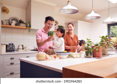 Asian Family Unpacking Local Food In Zero Waste Packaging From Bag In Kitchen At Home - Powered by Shutterstock