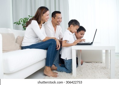 Asian Family Using Laptop