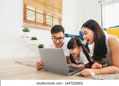 Asian Family Using Laptop Computer To Surf Internet / Online Shopping, Happy Family With Technology Concept