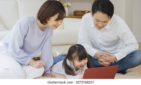 Asian Family Using A Personal Computer