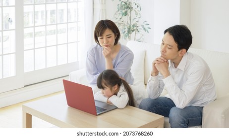 Asian Family Using A Personal Computer