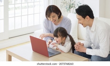 Asian Family Using A Personal Computer