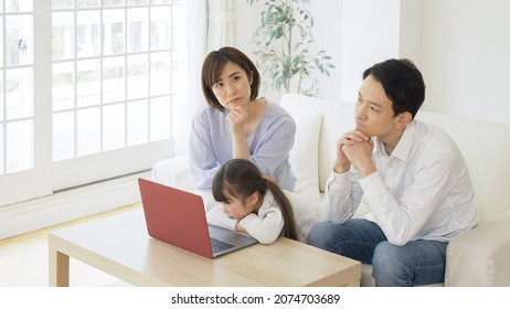 Asian Family Using A Personal Computer