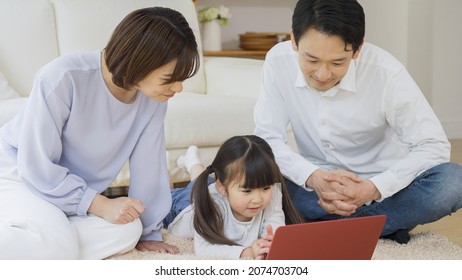 Asian Family Using A Personal Computer