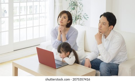 Asian Family Using A Personal Computer