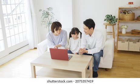 Asian Family Using A Personal Computer