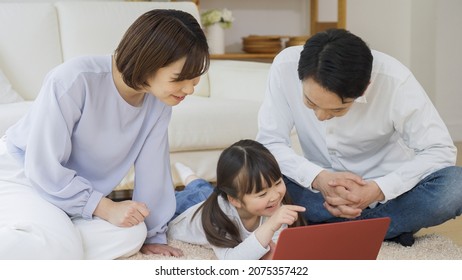 Asian Family Using A Personal Computer