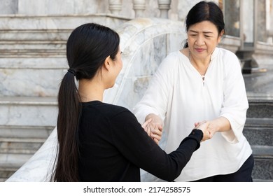 Asian family value with daughter taking care of aged senior mother, filial piety concept