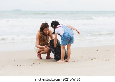 Asian family volunteers and children collecting garbage on the beach. Group of environmental help to keep nature clean up and pick up garbage. Concept of conservation and pollution problems. - Powered by Shutterstock