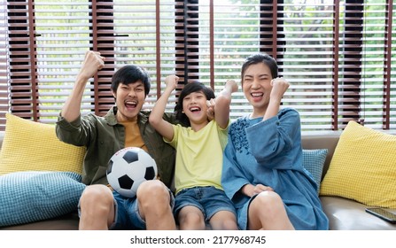 Asian Family Watching Football Sports Games On TV And Reacting Happy Exiting When Team Shoot The Ball Into The Goal.