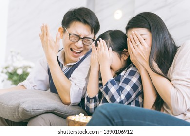 Asian Family Watching Scary Movies At Home