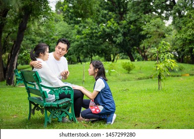 Asian Family,husband Holding Hand Comforting Wife,father Care Mother Depressive,alzheimer,child Girl Or Daughter Helping,support,depression Woman Patient,feel Sad In Outdoor Park,health Care Concept