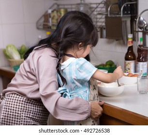 Asian Family,Mother Teaching Child Cooking In Kitchen. 