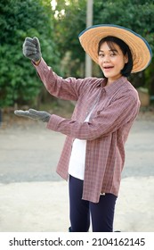 Asian Farmer Woman Pose Holding Product At Farm