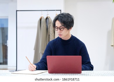 Asian Fashion Designer Working At The Office