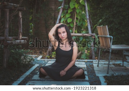 Similar – barefoot young woman sitting barefoot in a window frame