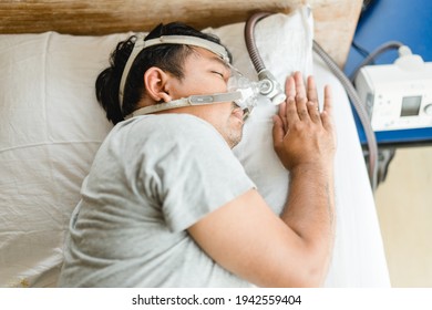 Asian Fat Man Wearing Cpap Mask Sleeping In Bed, Snoring Man.Obstructive Sleep Apnea Therapy. Cpap Therapy, Medical Health, Sleep Test, Good Sleep, Machine, Patient, Sleep Disordered Breathing.Sdb 