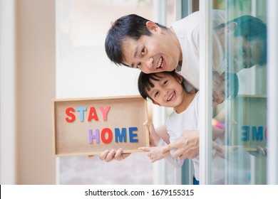 Asian father and daughter are holding the board with message