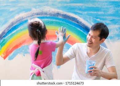 Asian Father And Daughter Painting The Wall Together With Fully Happiness Moment At Home, Concept Of Parent Role For Support The Child Education At Home And Learn Through Play For Kid Development.