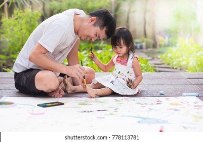 Asian Father And Daughter Are Playing By Color Painting Together With Fully Happiness Moment, Concept Of Learning Activity For Kid In Family Lifestyle