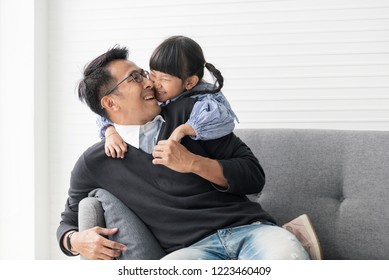 Asian Father And Daughter Playing And Kiss Together In Livingroom At Home.