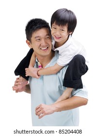 Asian Father Giving Piggyback Ride To His Son