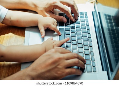 Asian father and his son is using the laptop computer at their home on sunday or holiday. - Shutterstock ID 1109864390