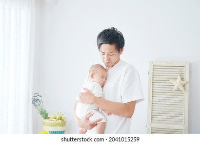 Asian Father Holding His Baby