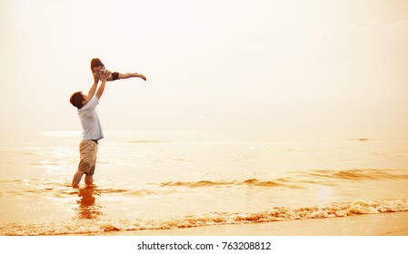 Asian Father And Little Girl Playing On The Sunset Beach , Dad Holding Daughter Flying At The Beach. Together Love Family Concept. Father's Day Banner