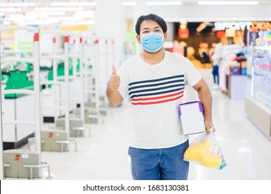 Asian Father Man Wearing Surgical Face Mask In Supermarket With Shopping Grocery In Supermarket Store.Panic Buying Man Holding Fruits Milk Powder For Baby Child Covid-19 Coronavirus Pandemic Symptoms.