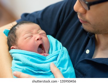 Asian Father And Newborn Baby Girl In Hospital