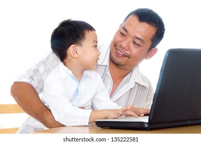 Asian Father And Son Using Laptop