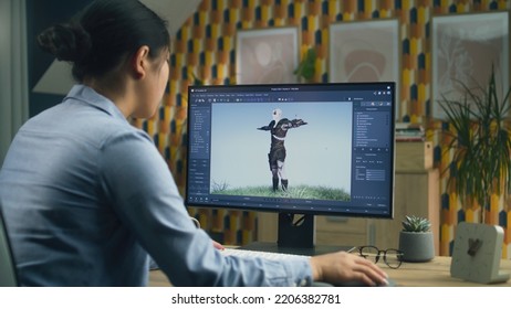 Asian Female 3D Designer Making Animation For Video Game Character Using Modern Computer With Software For Creating 3D Modeling Projects