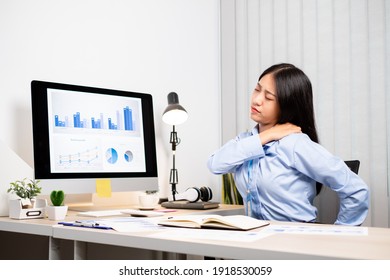 Asian Female Accountant Is Tired From Working In A Chair, Stretching To Relax And Relax While Working Hard At The Office.