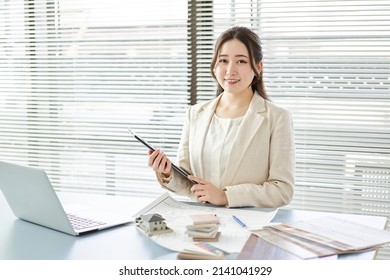 Asian Female Architect Standing At A Design Office