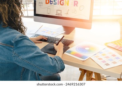 Asian female artist drawing something on graphic tablet. graphic designer working at office - Powered by Shutterstock