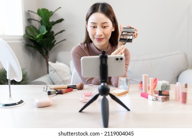 Asian Female Beauty Social Media Influencer Livestream Marketing Cosmetics A Make Up Tutorial Via Smartphone.