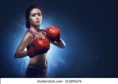 Asian Female Boxer Athlete Ready For Fight On Blue Background