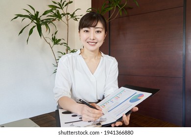 Asian Female Business Woman Hearing At An Online Meeting